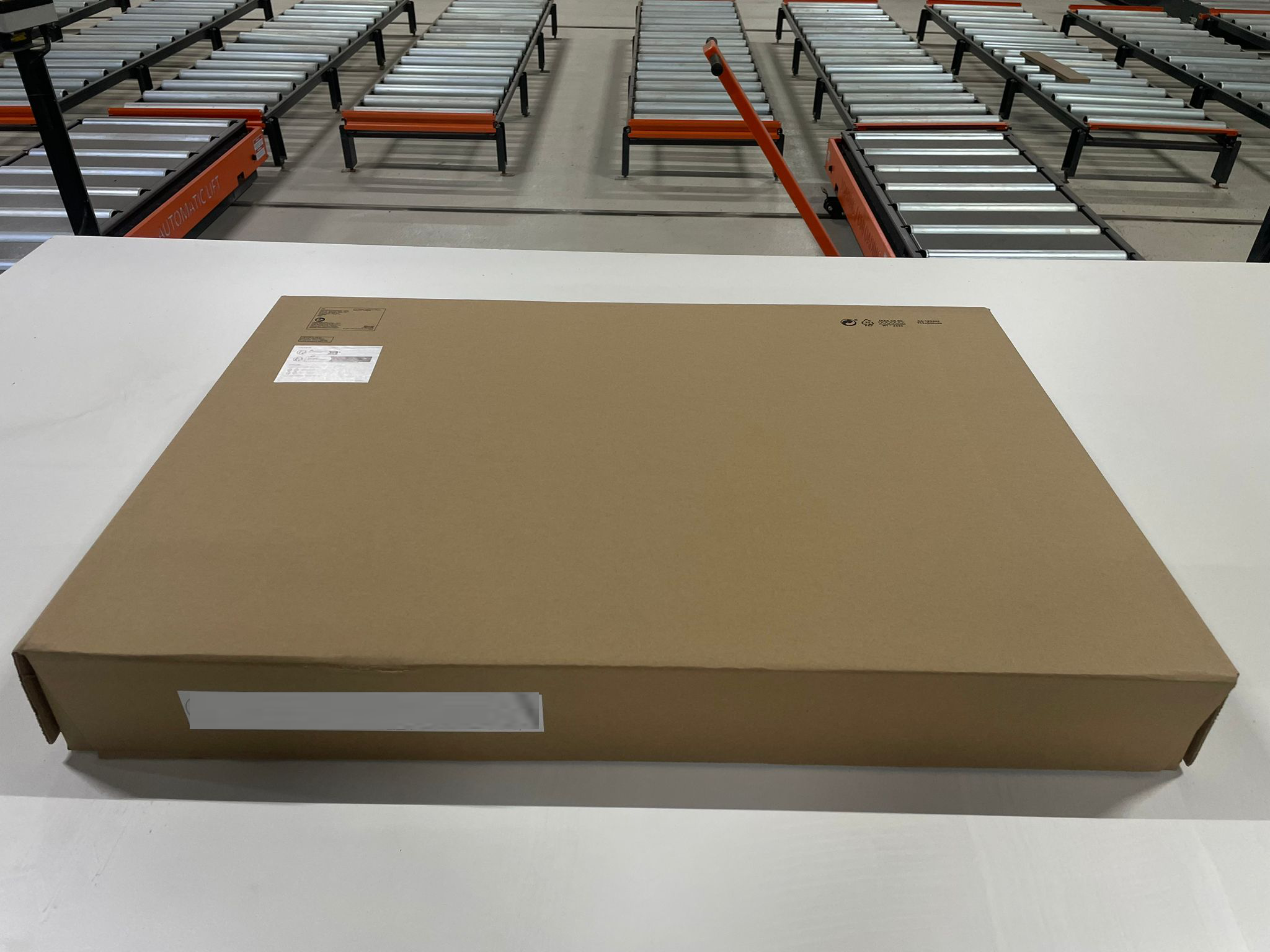 Export-Ready Flat-Pack Furniture Box on Roller Conveyor